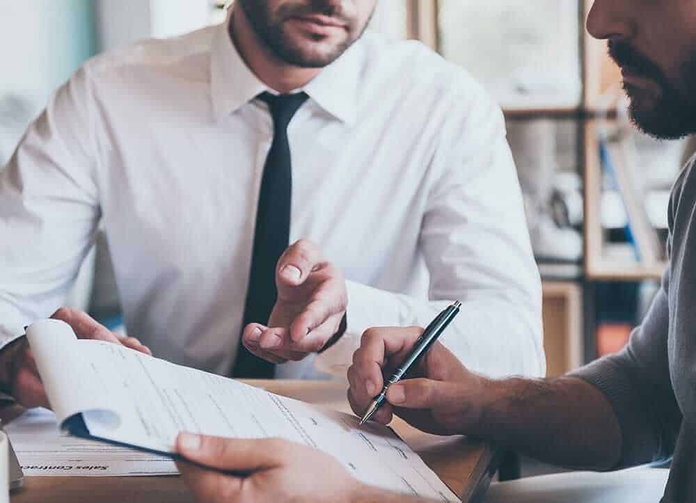 man signing a contract