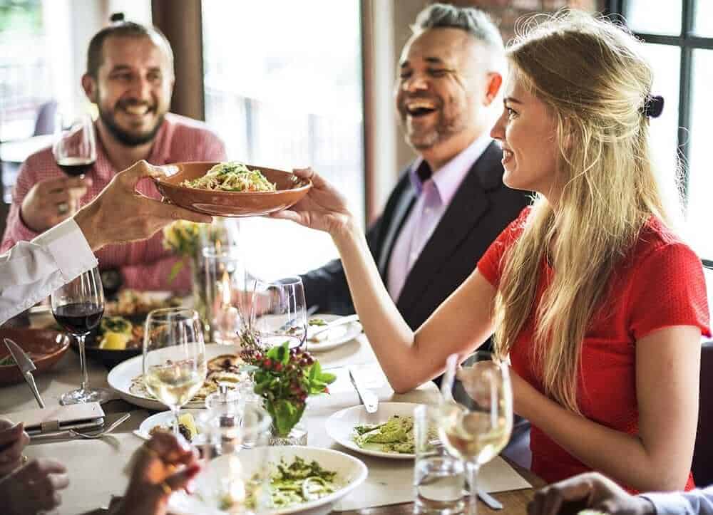 friends laughing during dinner night