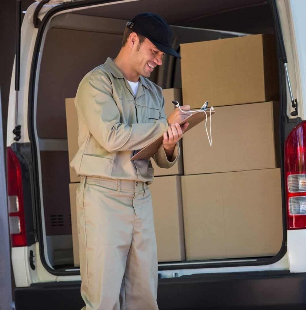 Delivery man checking boxes