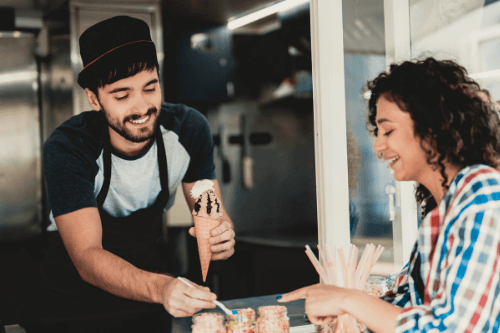 Man serving ice cream from food van