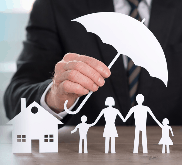 Man holding umbrella over family