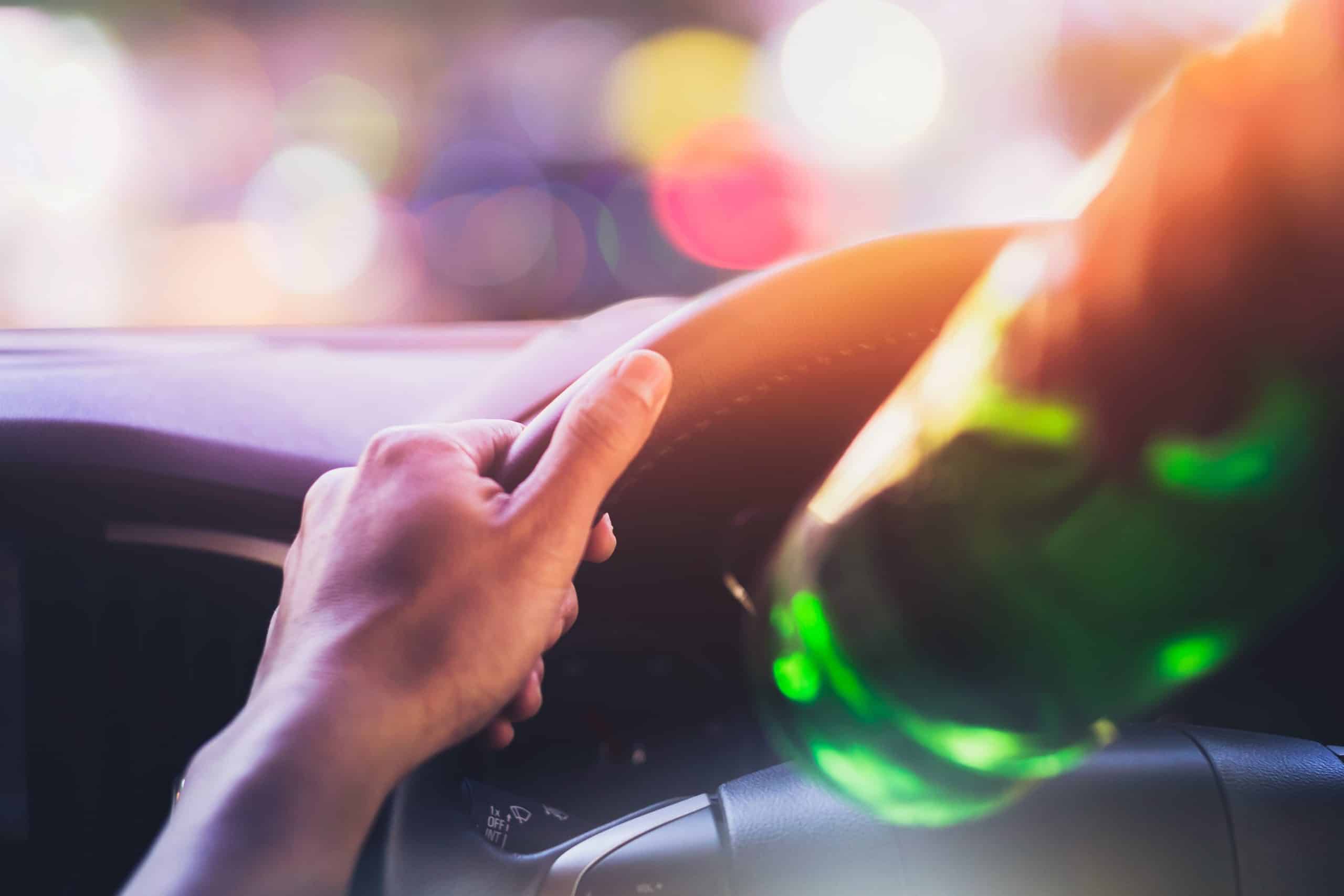 Man drinking behind wheel