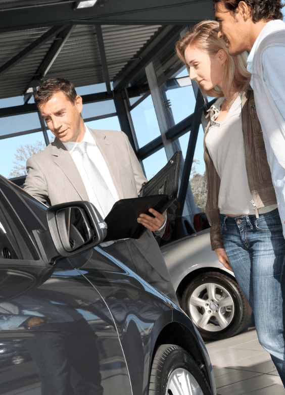 Car salesman with customers