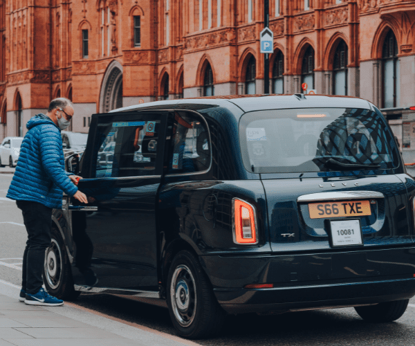 Man getting into taxi