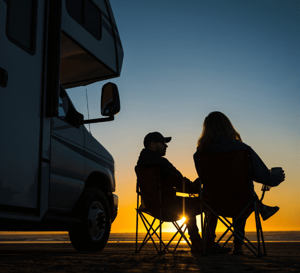 Couple relaxing outside motorhome